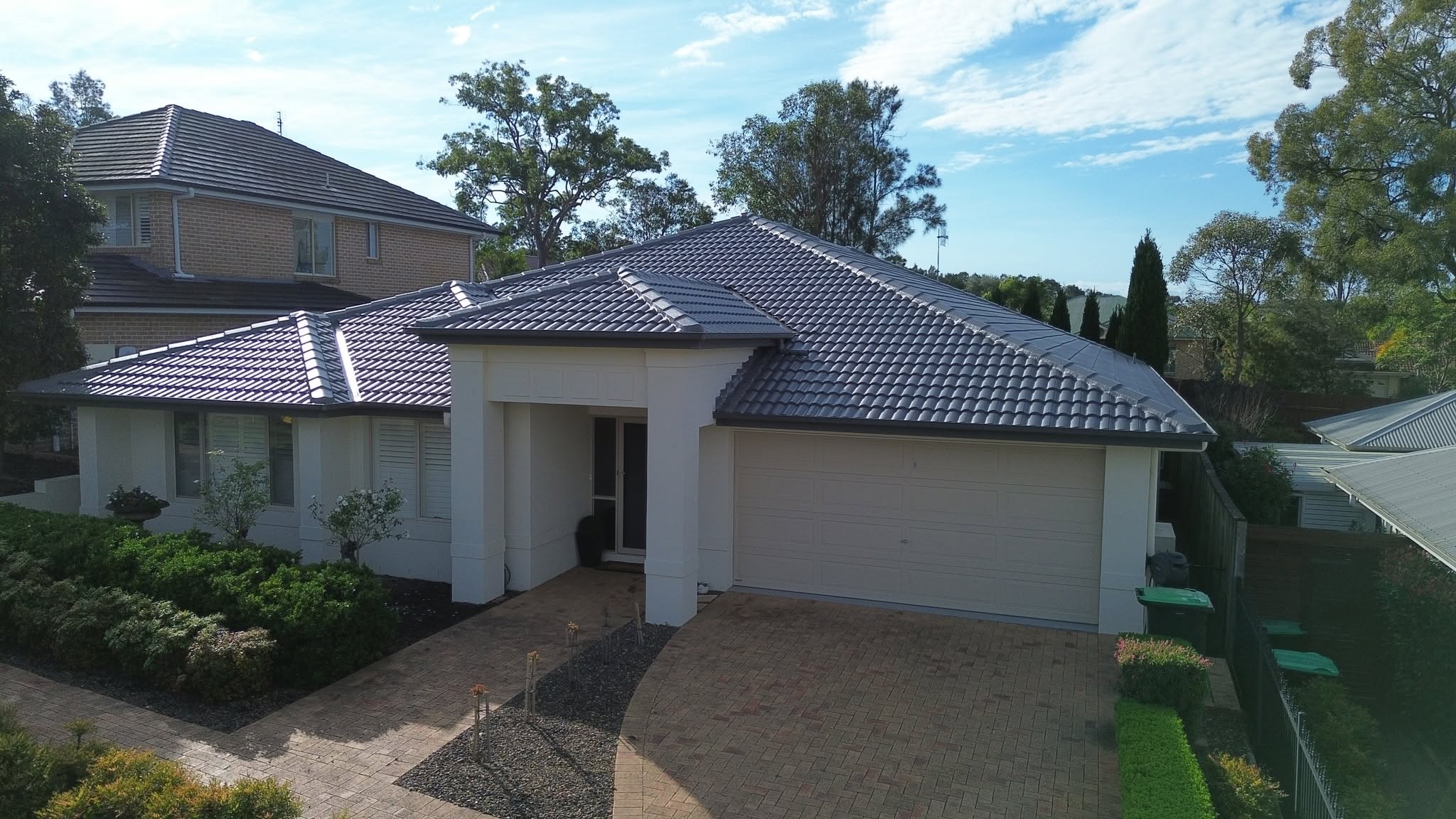 Aerial view of a dark tile roof sealed after roof leak detection in Newcastle