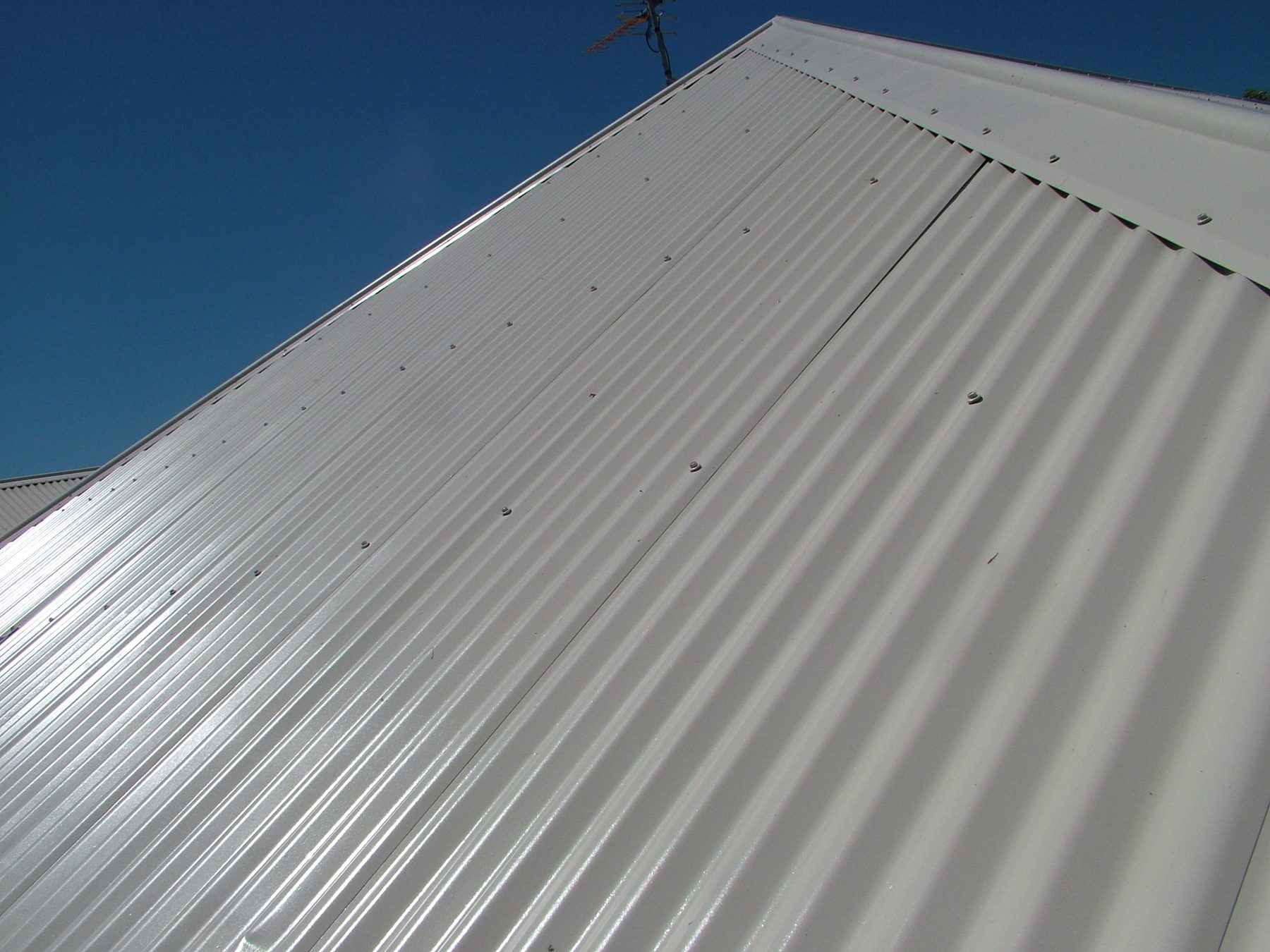 Close view of a re-coated metal roof after roof restoration