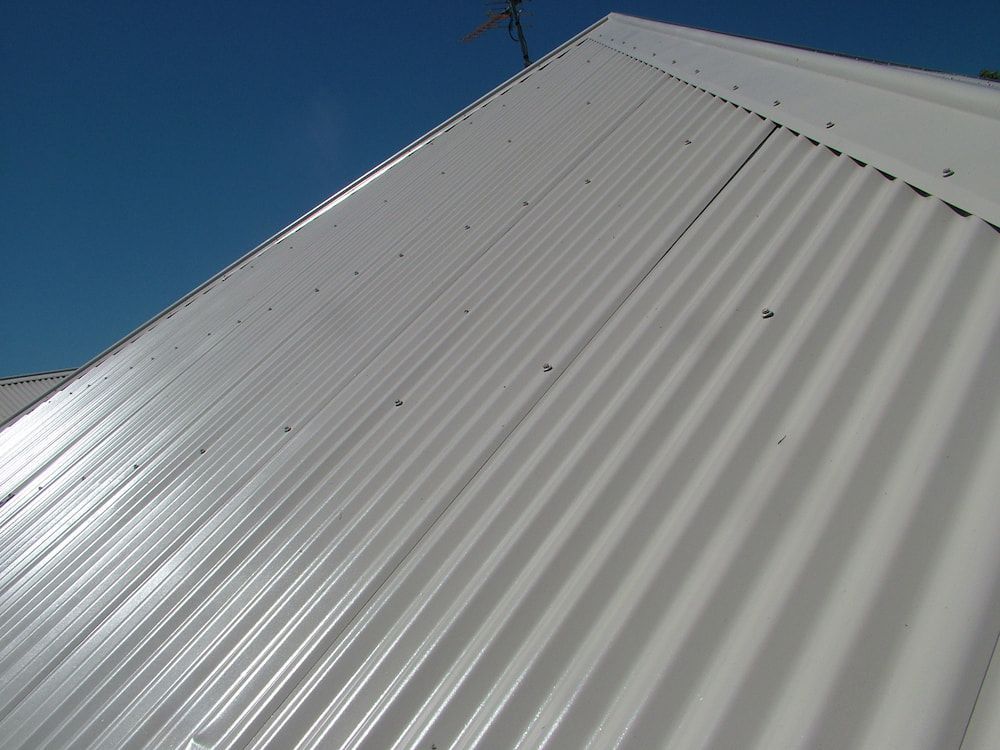 Freshly restored white roof against a blue sky on a Hunter region home