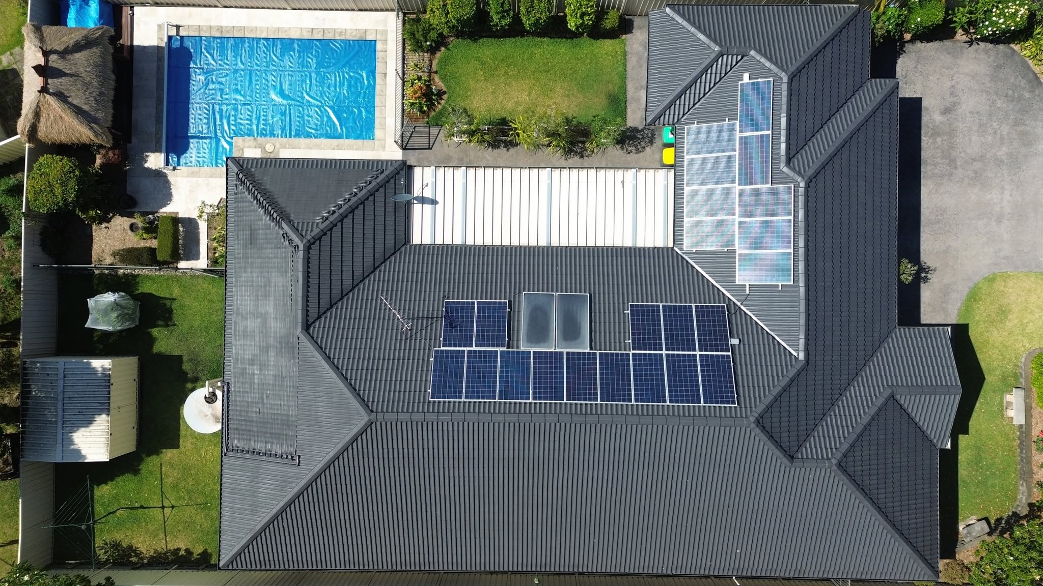 Storm-exposed charcoal tile roof assessed for an insurance roof claim