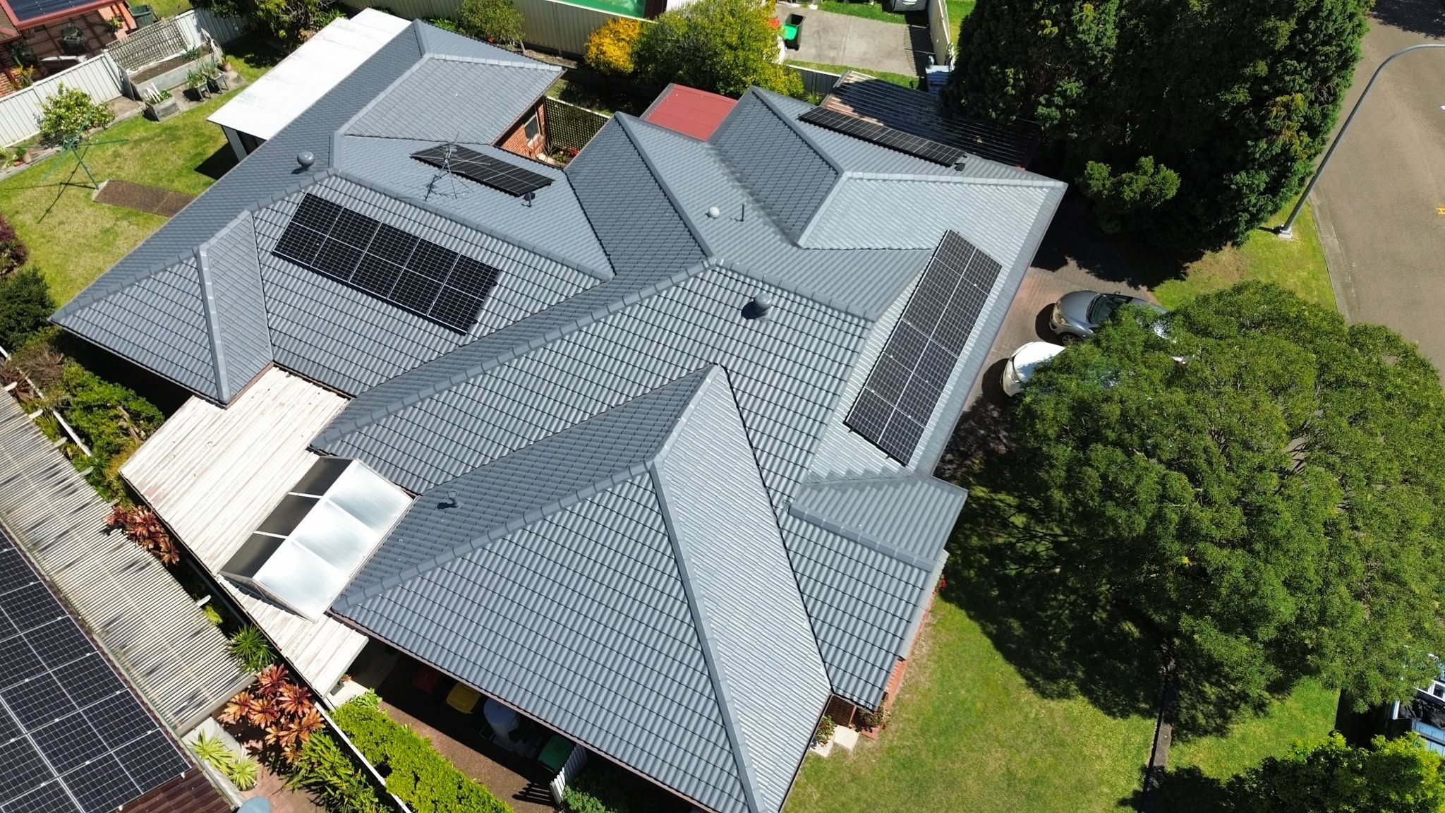 Grey tile roof valley and flashing checked during a roof leak inspection