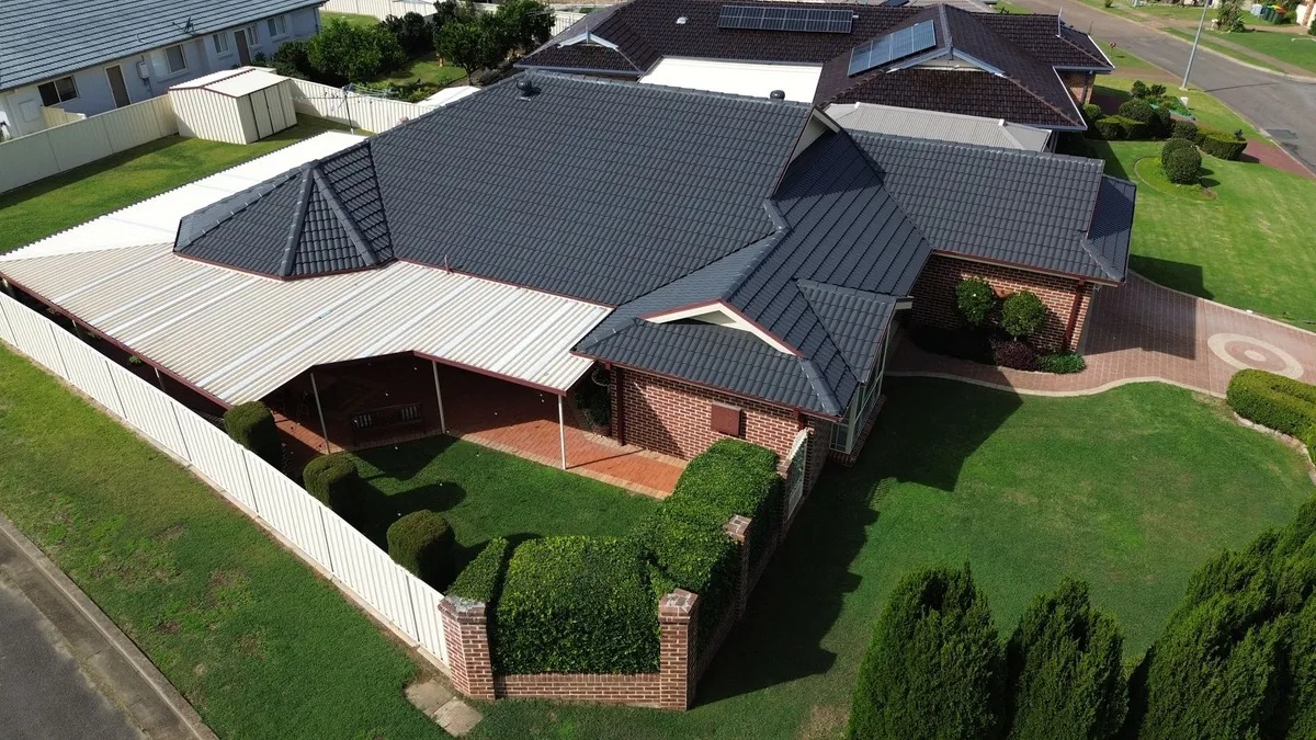 Aerial view of a restored dark tile roof on a Lake Macquarie brick home