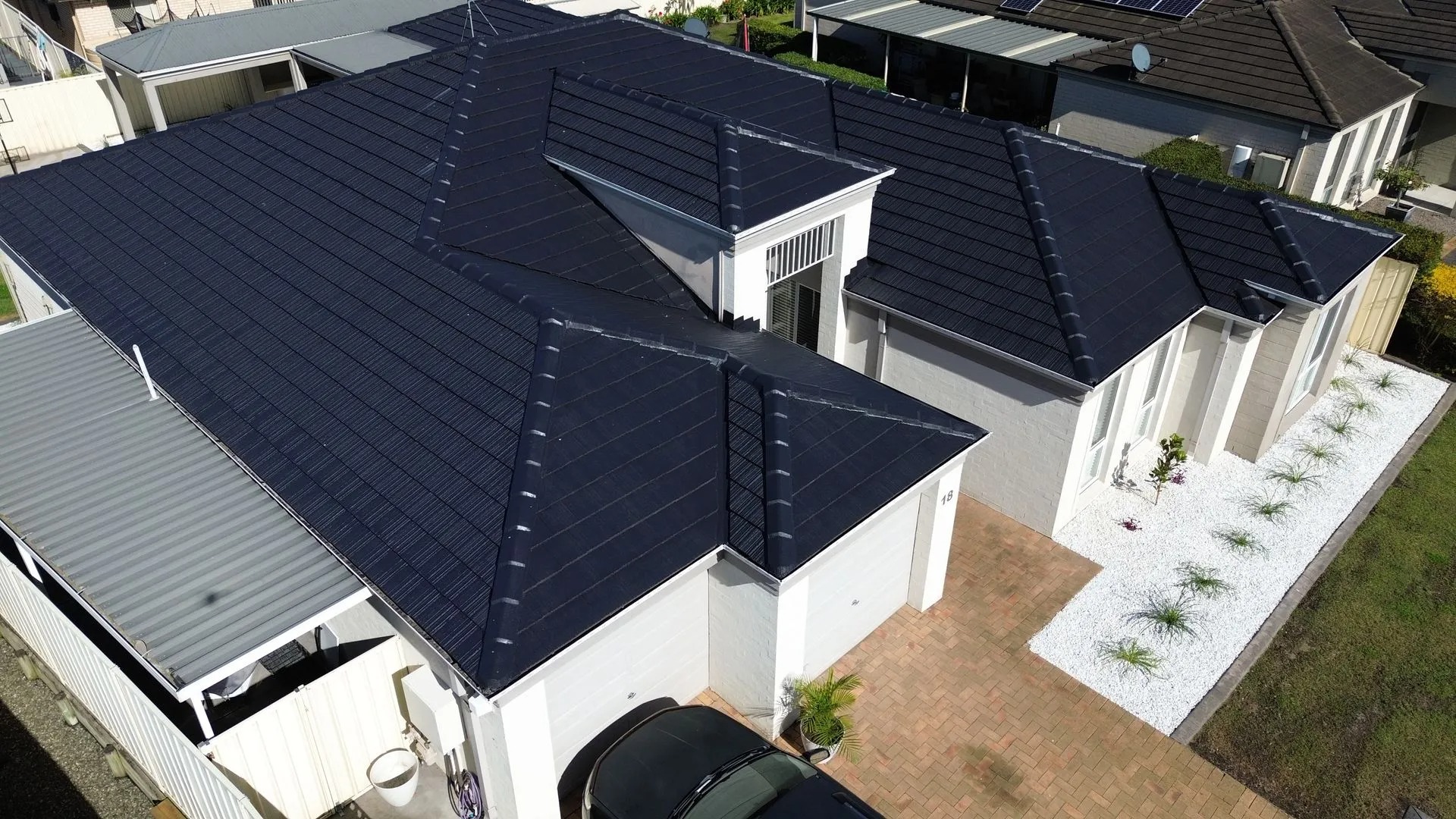 Aerial view of a charcoal tile roof restored by Roof Restoration Masters on a Newcastle home