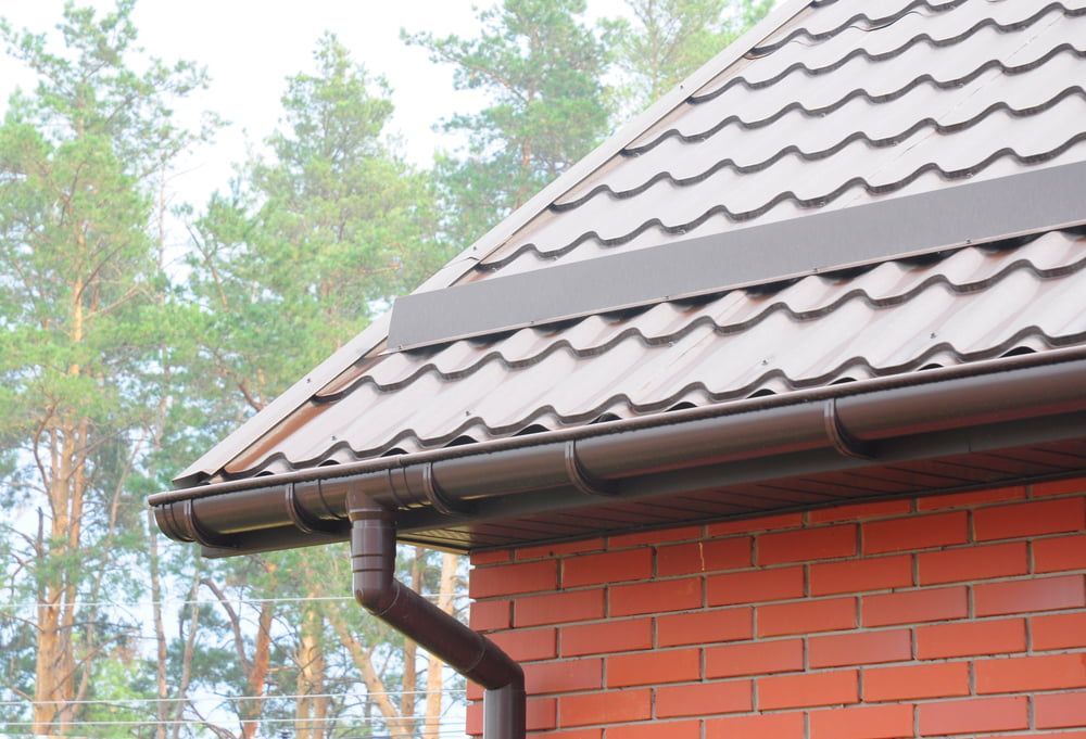 Roofers inspecting a roof to track down the source of a leak