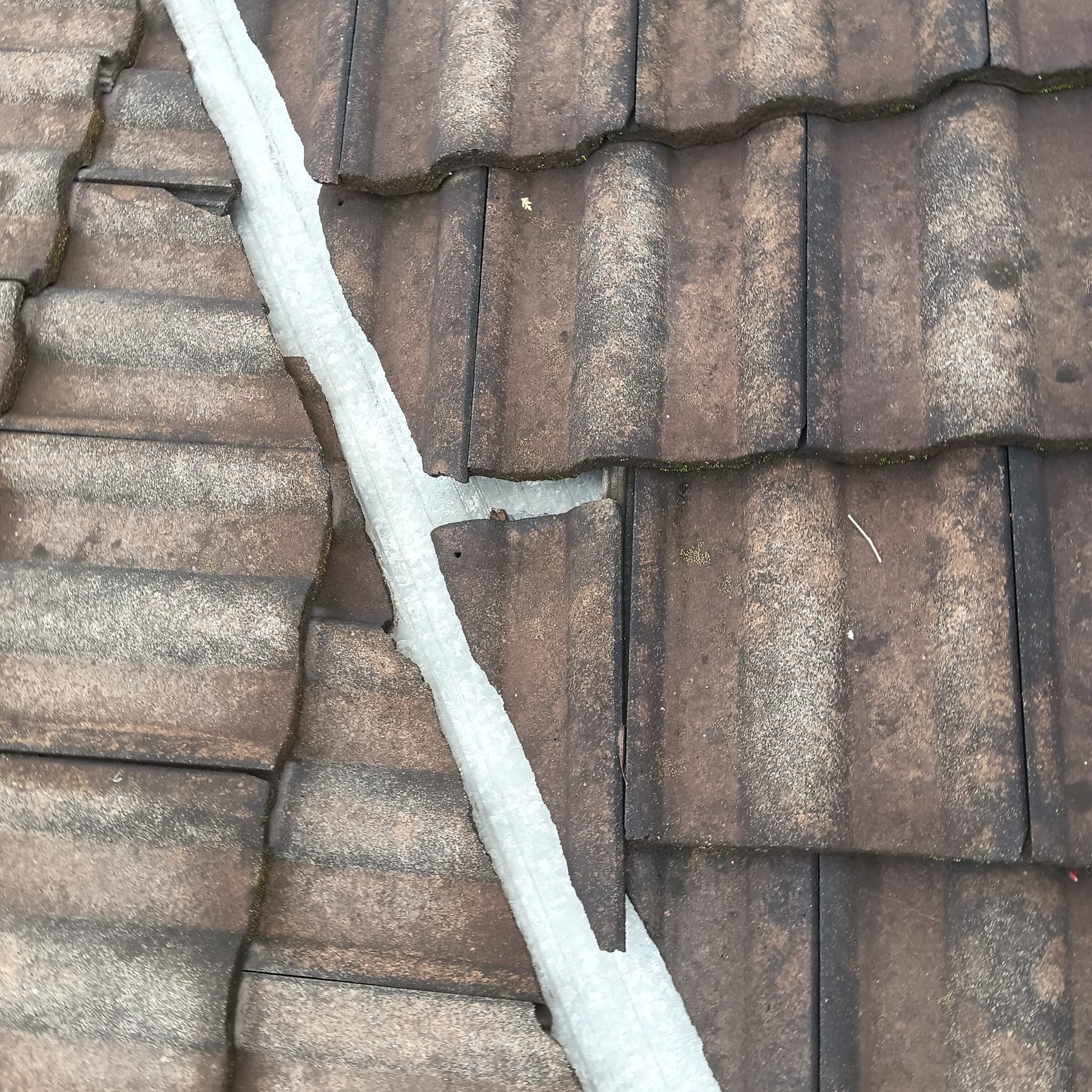 Roof valley and pipe flashing checked during leak detection on a Hunter Valley roof