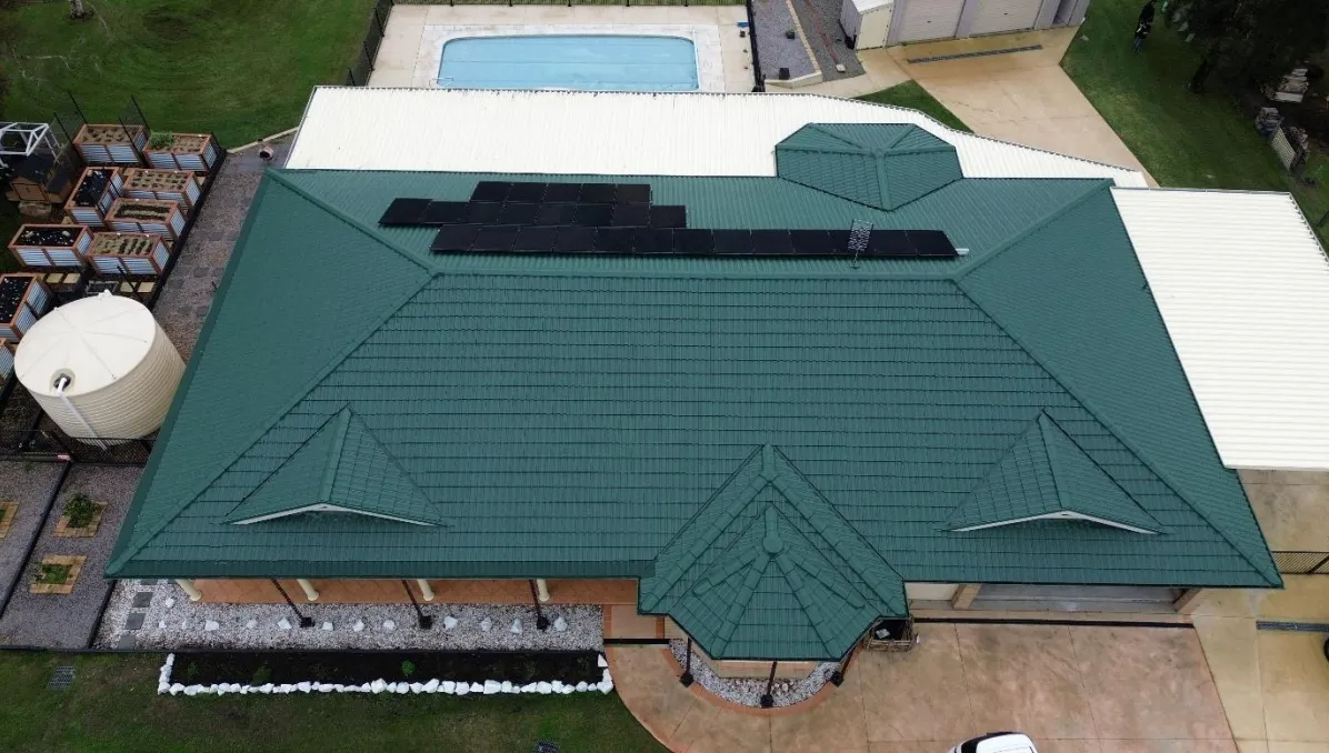 Aerial view of a large green metal roof restored by Roof Restoration Masters on the Central Coast