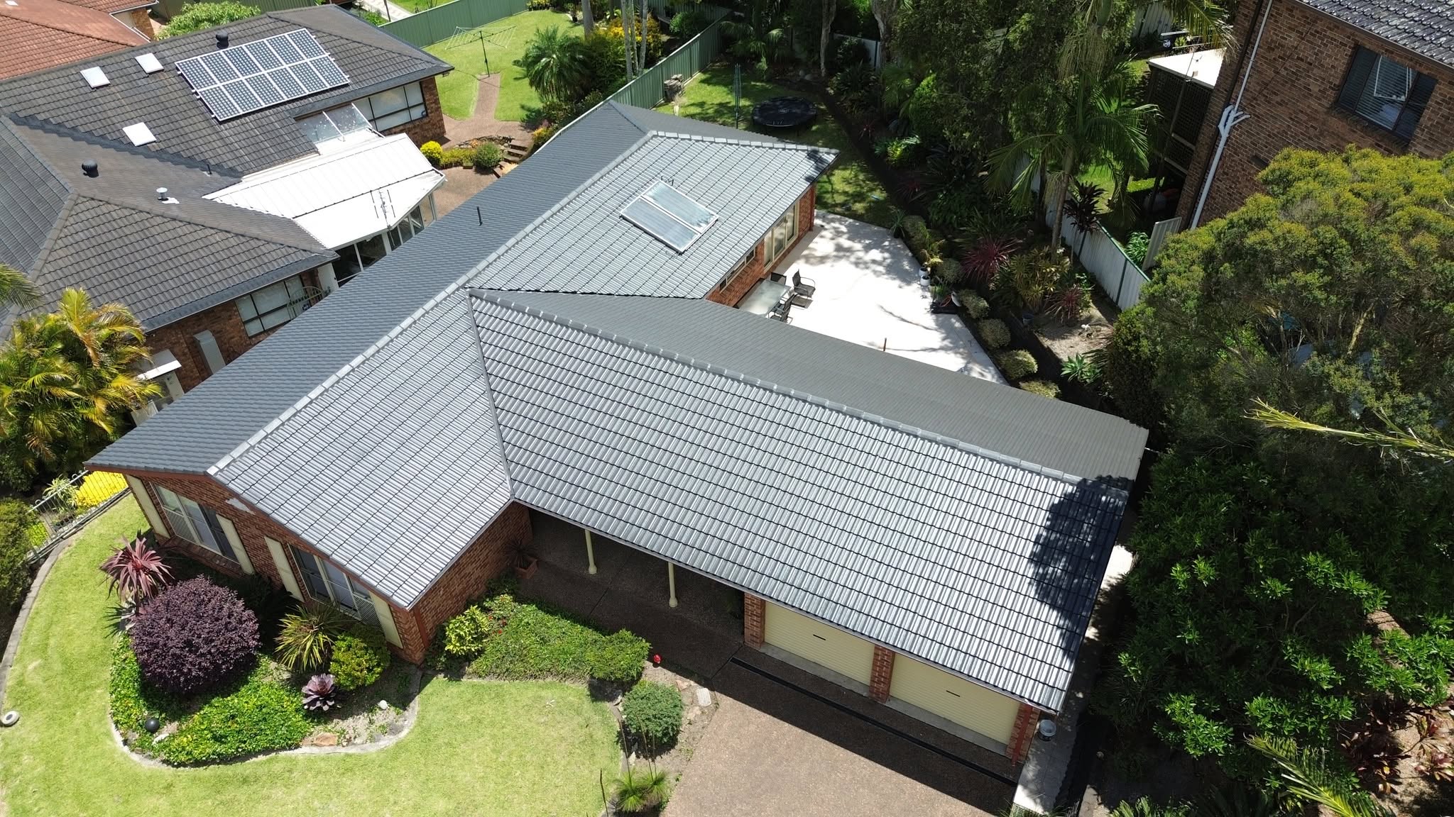 Aerial view of a slate-grey tile roof after roof repairs in Newcastle