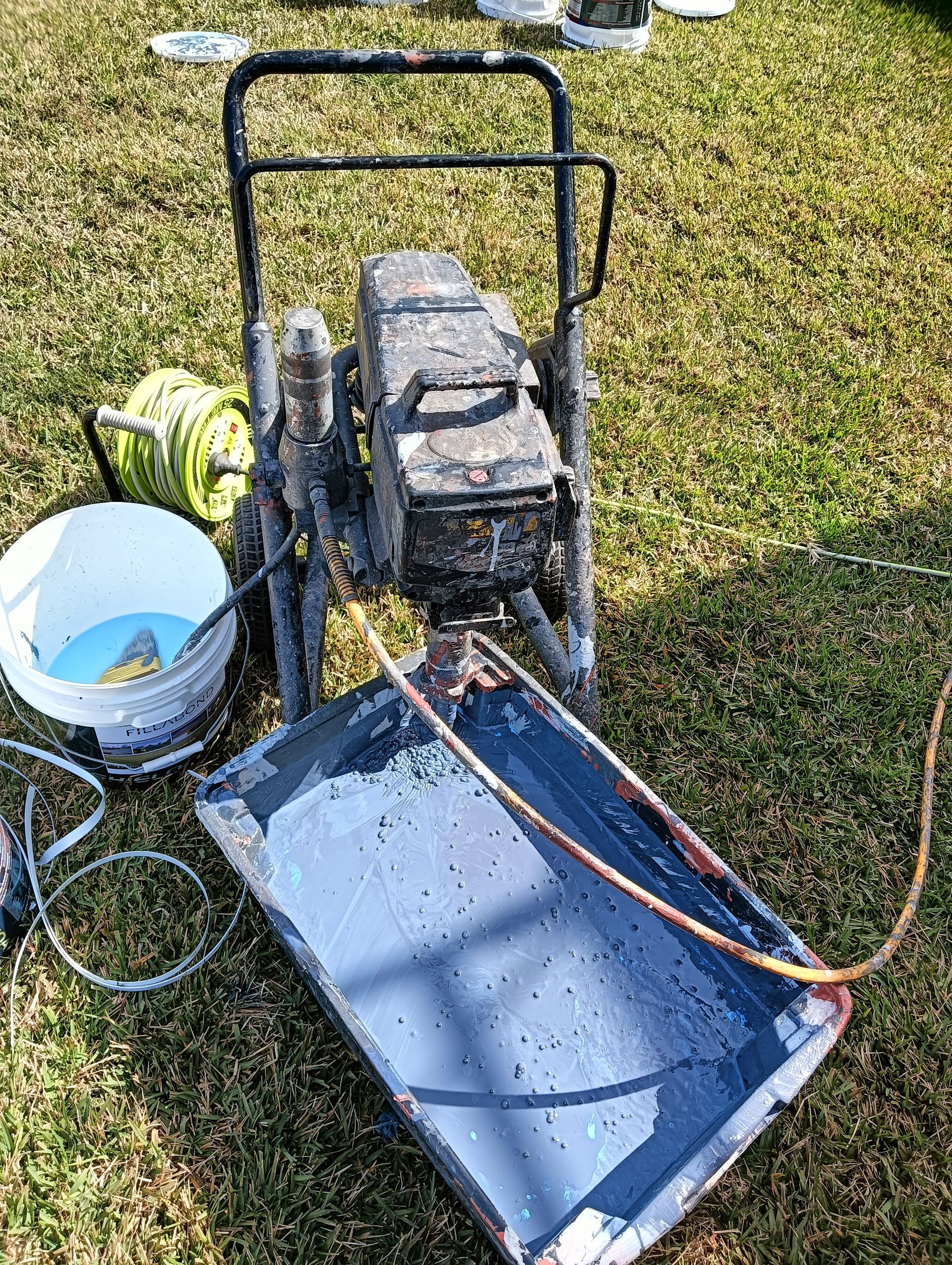 Roof painter coating a tile roof on a Hunter region home
