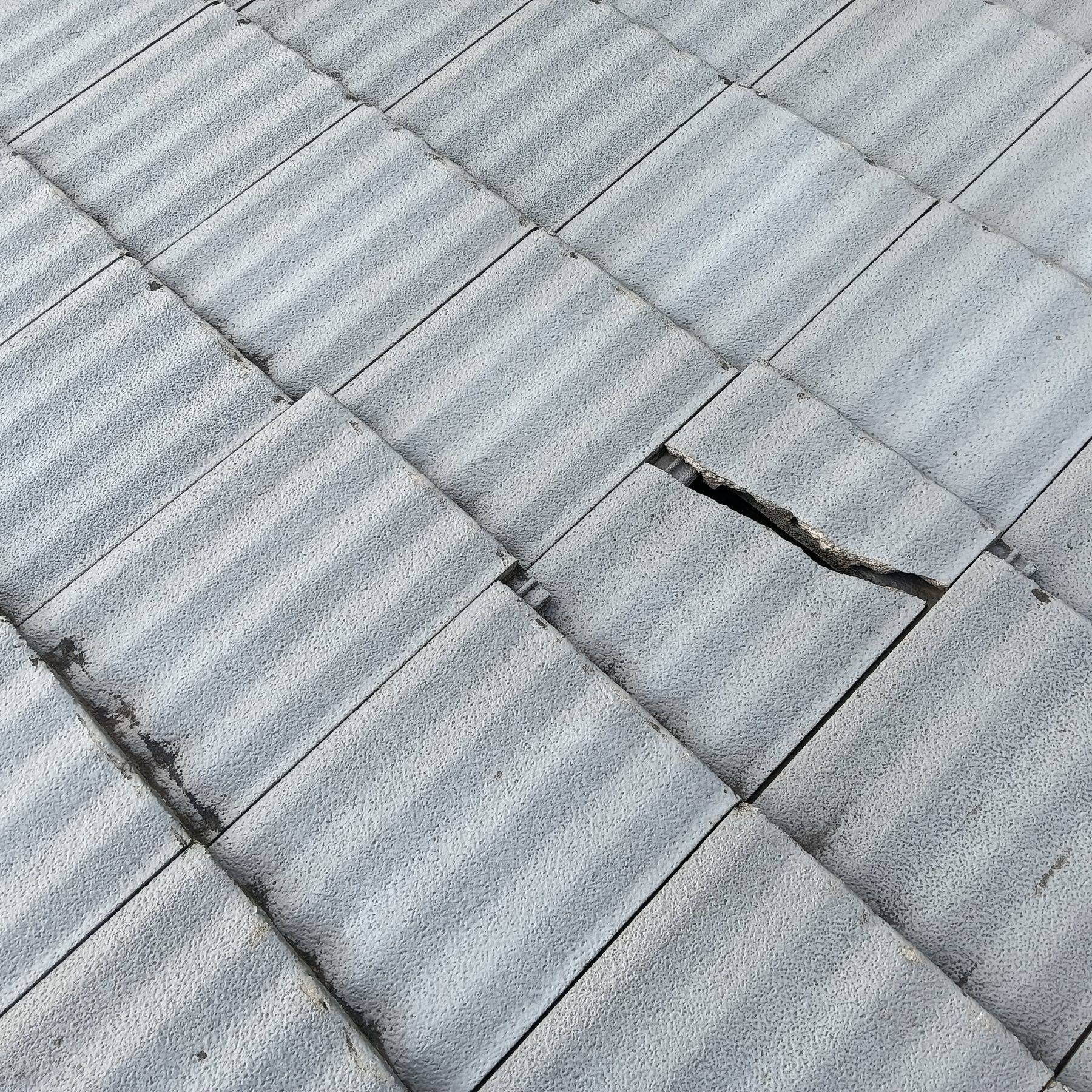 Cracked concrete roof tile found during roof repairs on a Lake Macquarie home