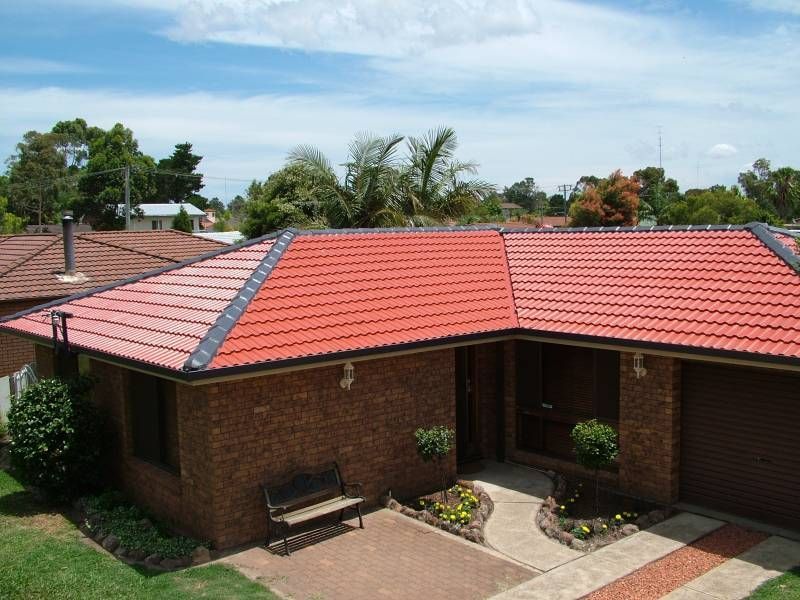 Brick home in Newcastle with a freshly restored red tile roof