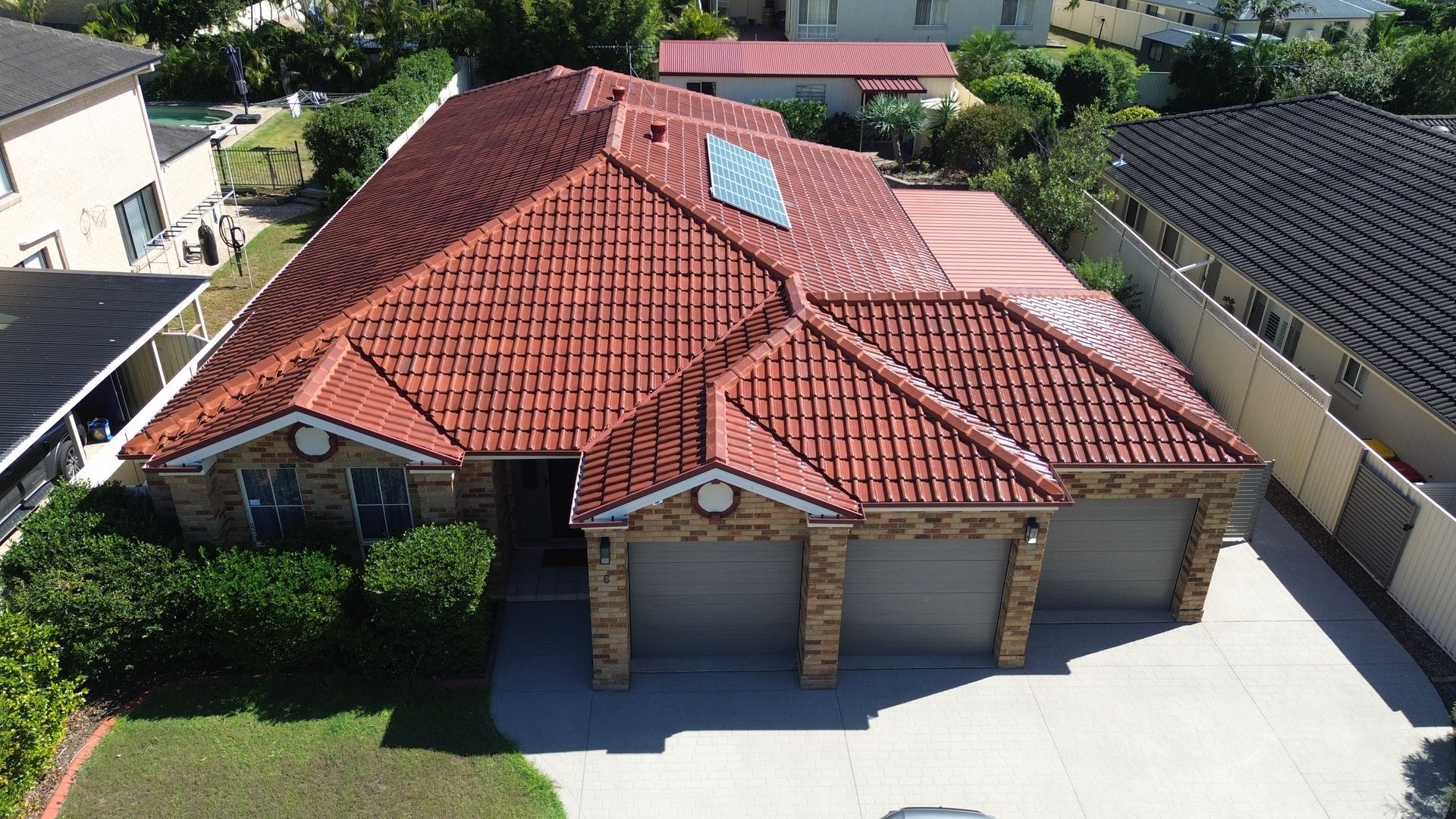 Aerial view of a terracotta tile roof after cleaning and re-coating