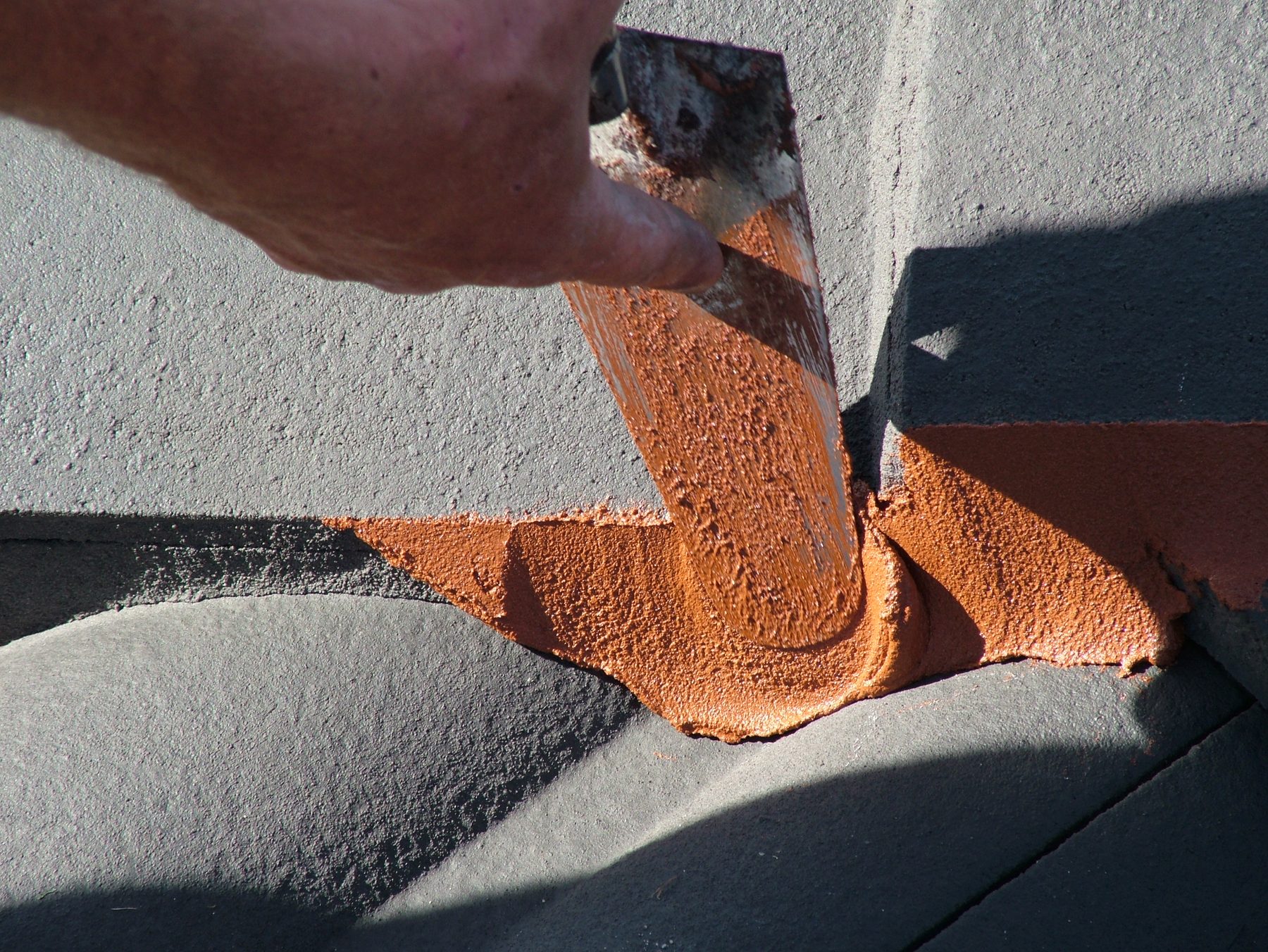 Flexible pointing applied to ridge capping during a roof restoration